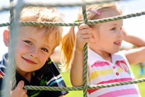 Kinder im Sonnenschein am Klettergerüst